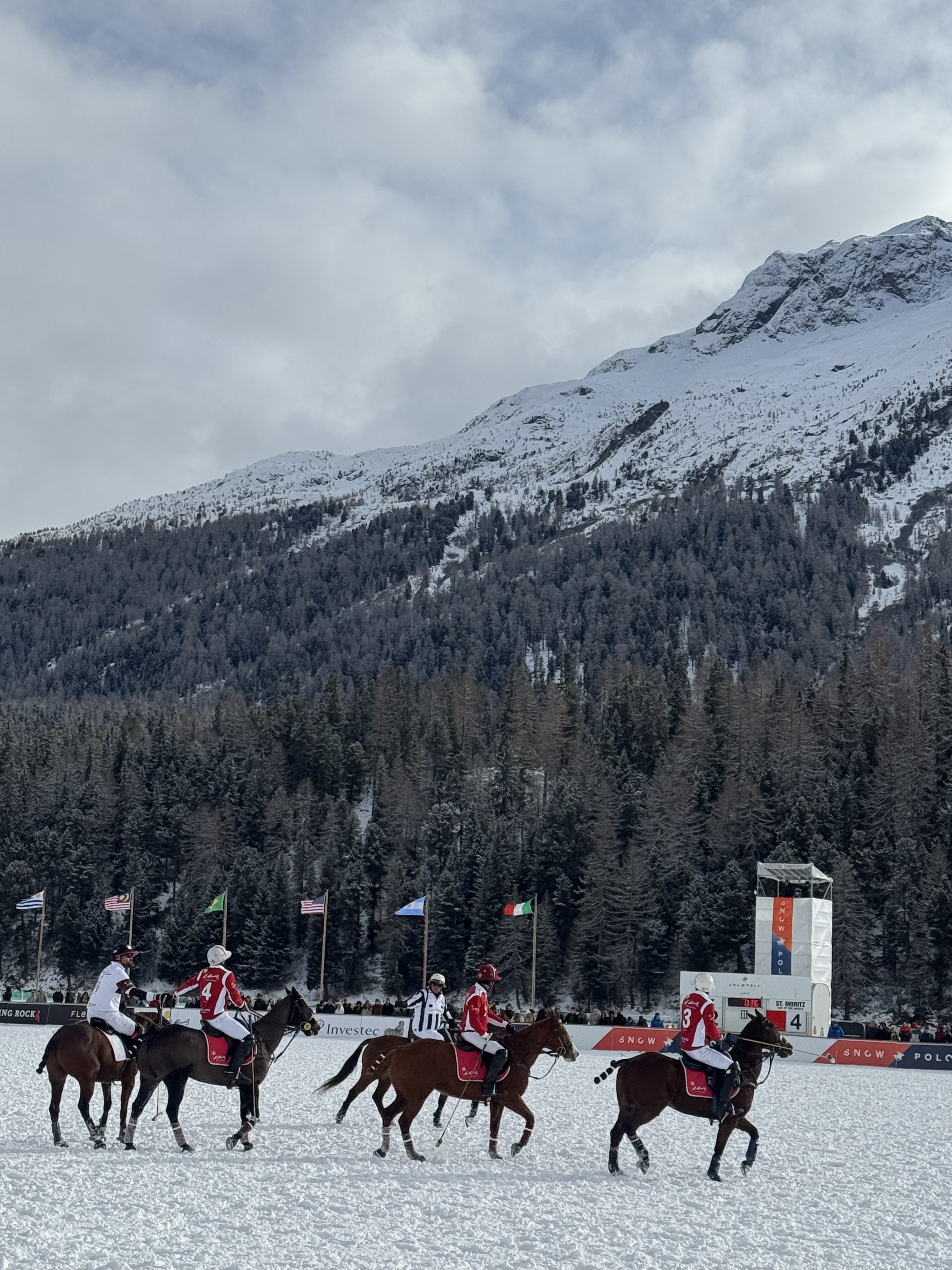 Snow polo on a frozen alpine lake with the mountains behind